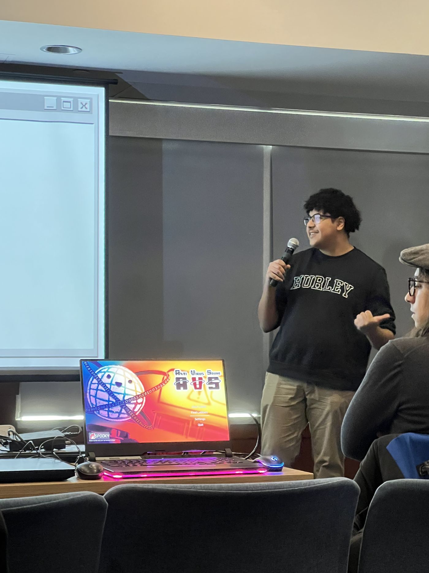 Marwan in a speaker pose during presentation setup.