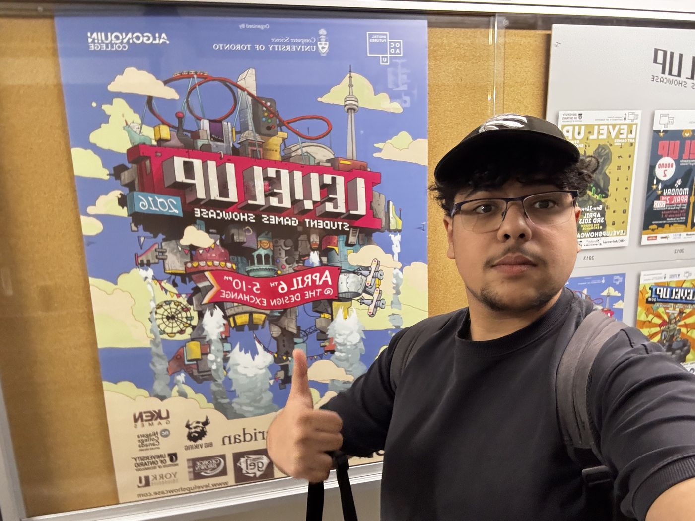 Marwan behind a Level Up showcase poster.