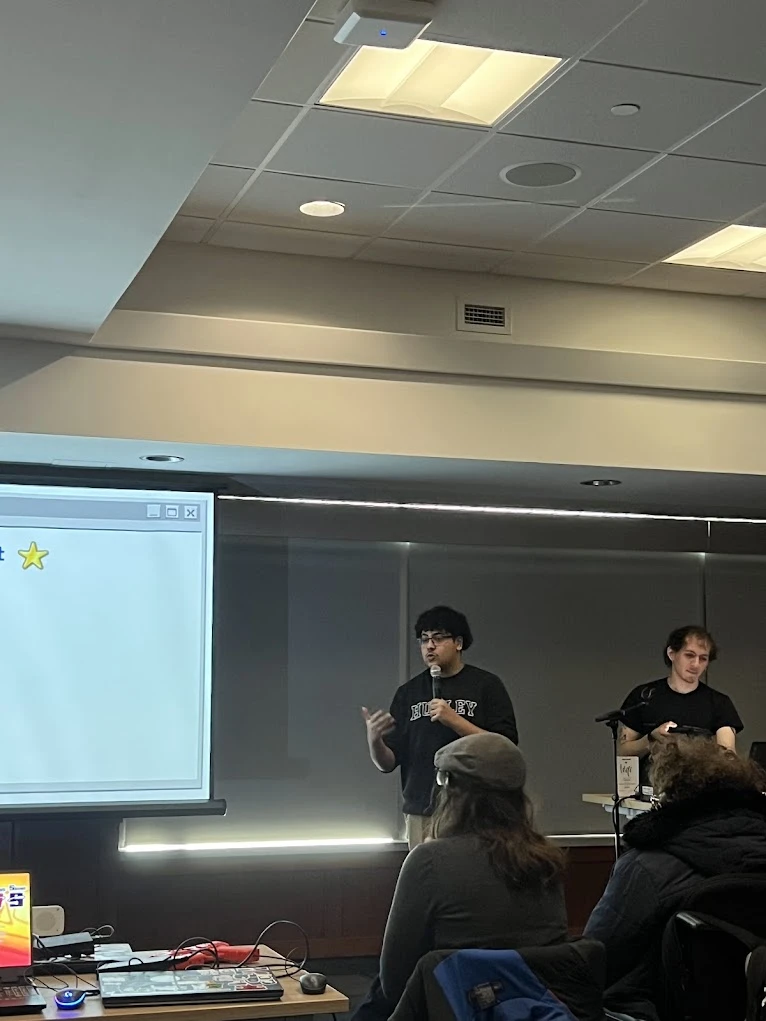 Marwan presenting Anti-Virus Squad to an audience with a microphone.