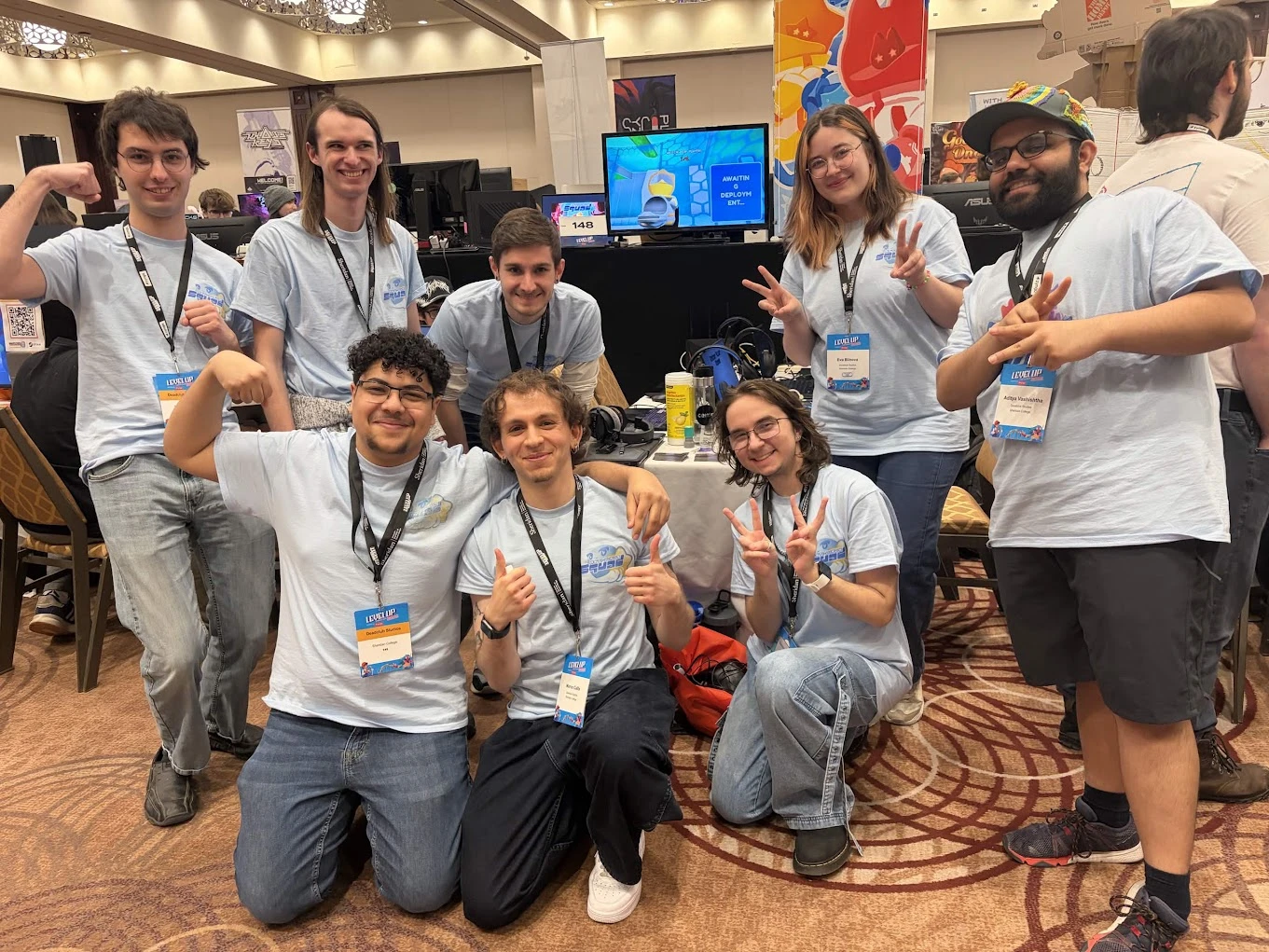 The Deadclub Studios team posing together at the Anti-Virus Squad booth at Level Up Toronto.