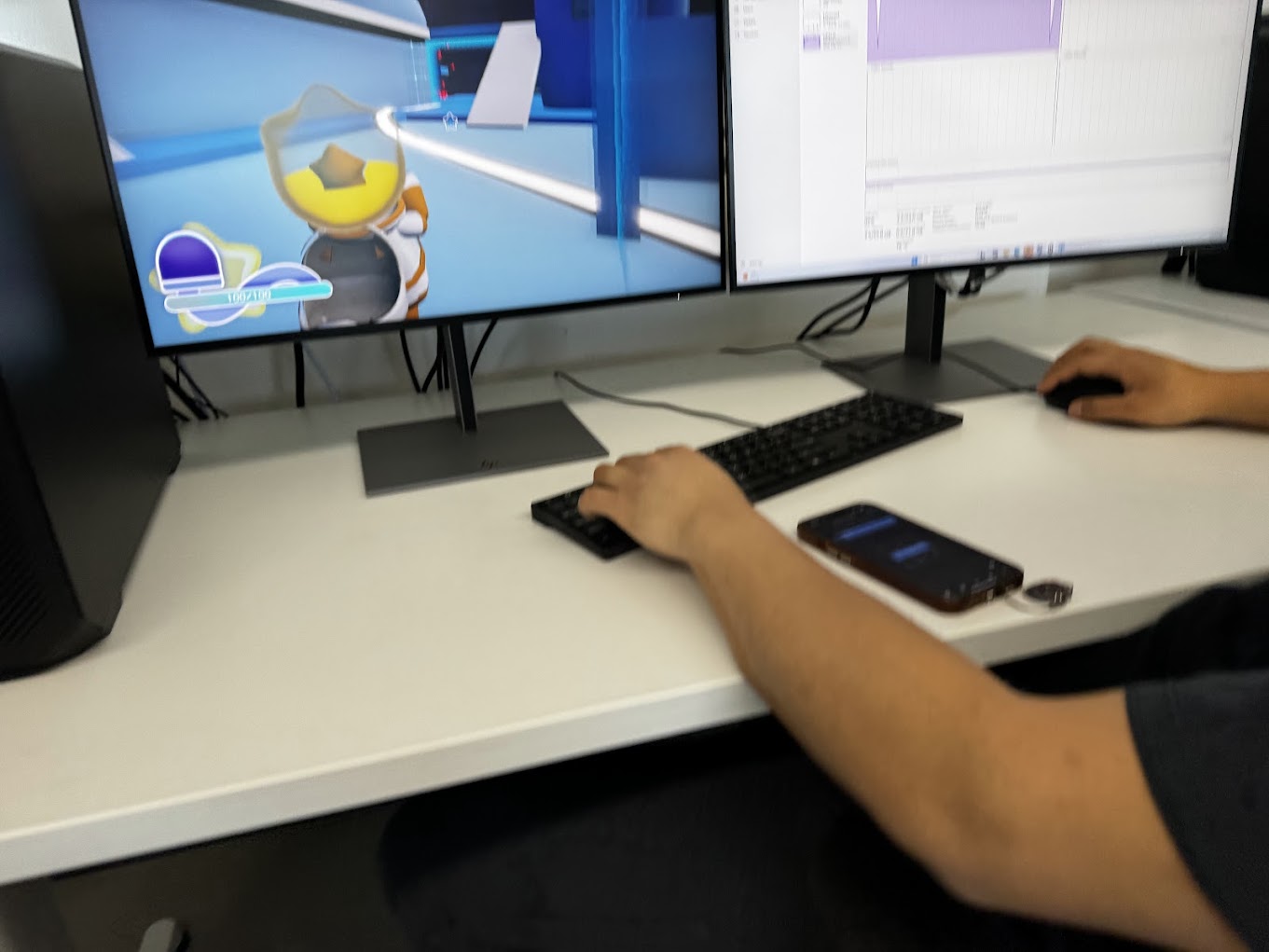 Testing a live build on one monitor while cutting trailer footage in an editing timeline on the
                other.